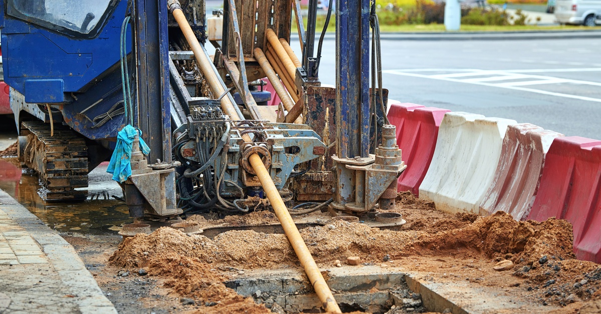 A horizontal directional drilling machine in action, using a trenchless method for installing underground utilities.